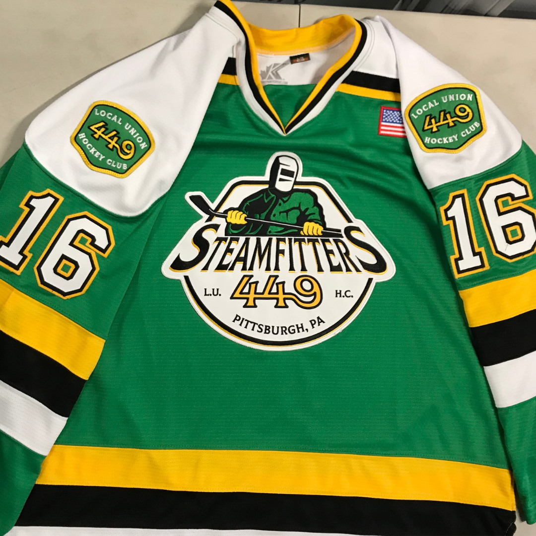 Custom pro-style hockey jersey—green, yellow, and white—with an embroidered pro twill logo on the front and shoulders.