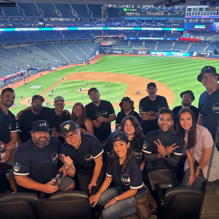 Company photo of custom full button baseball jerseys made to wear for a company rental of a corporate box at the Toronto Blue Jays game