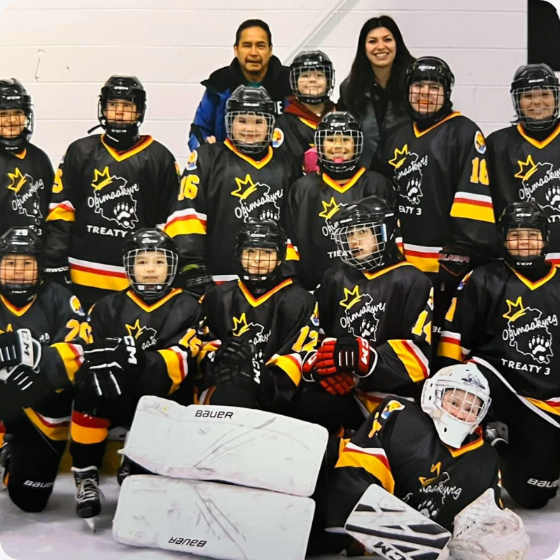 A youth hockey team with black and yellow custom Jerseys Made Easy jerseys.