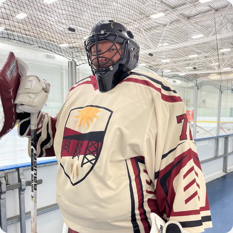 A beer league hockey goalie wearing a custom Jerseys Made Easy hockey jersey and hockey gear.