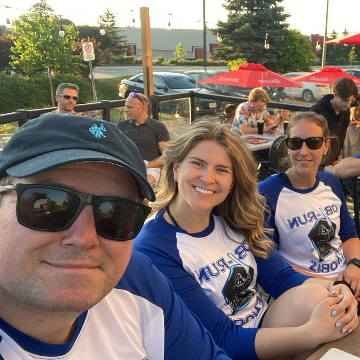 Beer league slo-pitch team showing off custom printed 3/4 sleeve baseball jerseys at the pub after a game