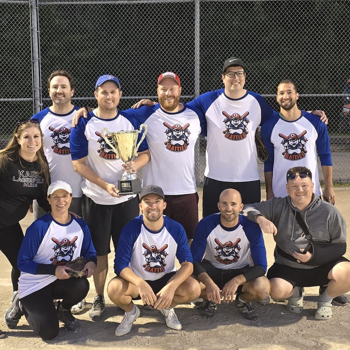 A team photo showing off their championship in their custom printed 3/4 sleeve baseball jerseys 